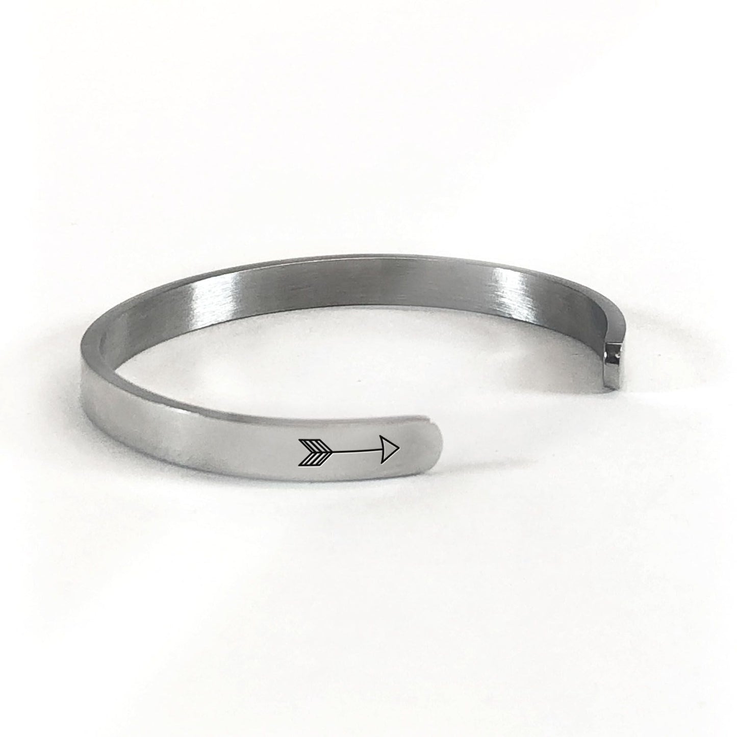 The love between a mother and daughter knows no distance bracelet in silver rotated to show arrows and cuff opening
